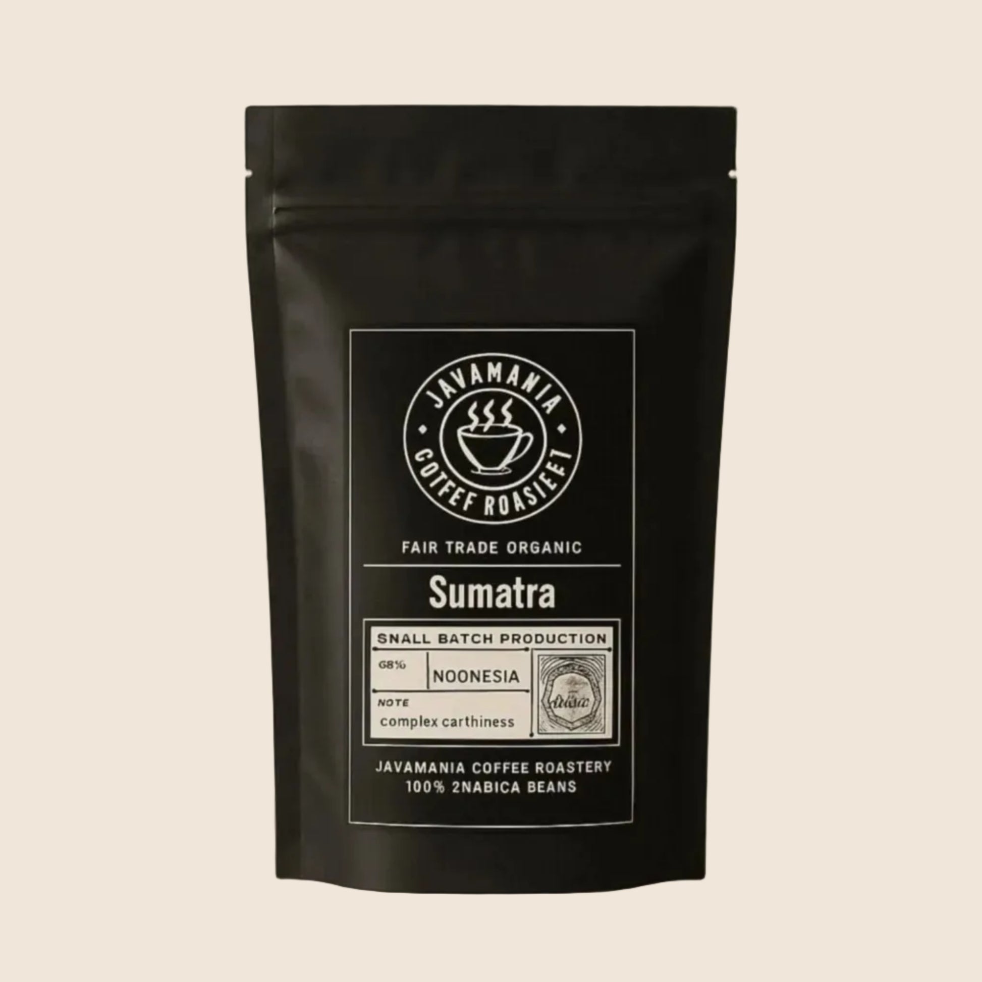 Javamainia Black coffee bag labeled Fair Trade Organic Sumatra on a soft beige background, 