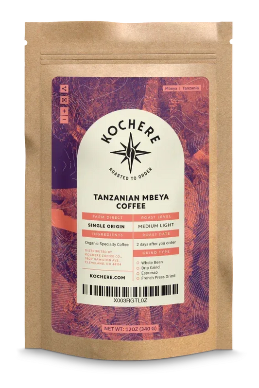 Bag of Tanzania Mbeya AB medium‑light roast coffee with pear, floral, jasmine, and strawberry notes